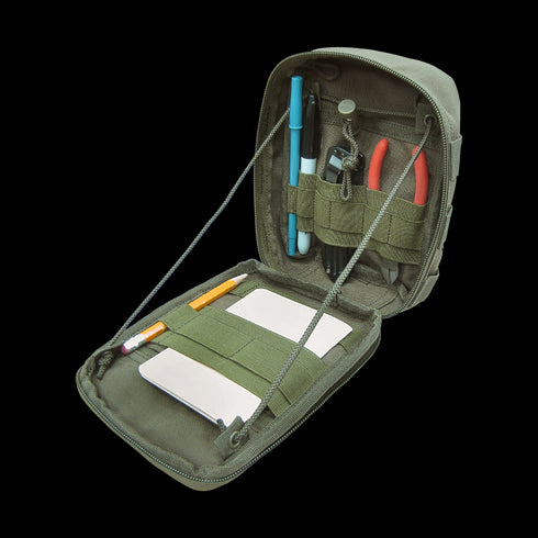 The Condor Sidekick Pouch - MultiCam Black unzips to reveal notebooks, pens, a pencil, marker, pliers, and a multitool held by elastic bands—ideal for EDC or keeping essentials organized at the range.